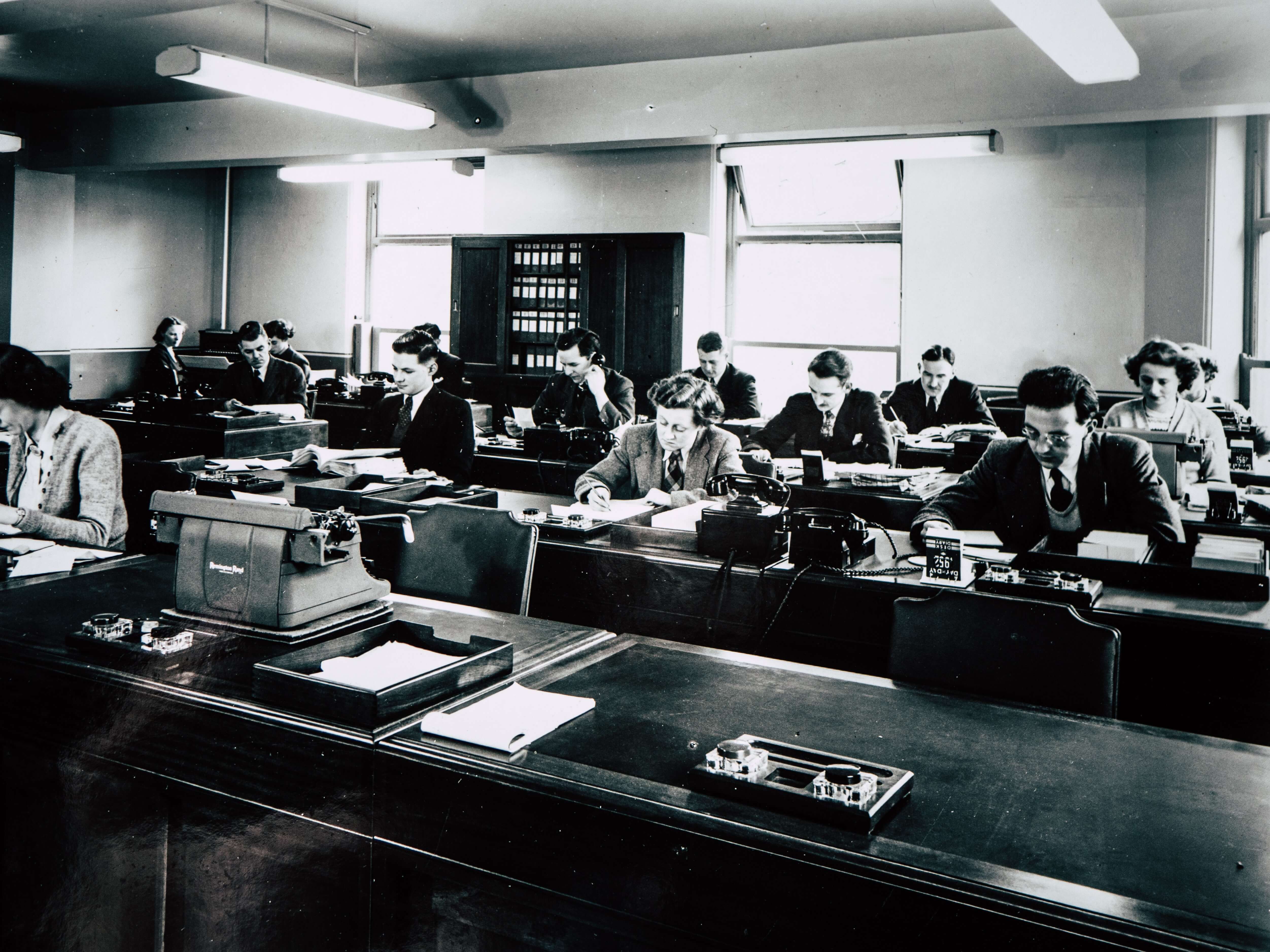 retro photo of office workers on typewriters