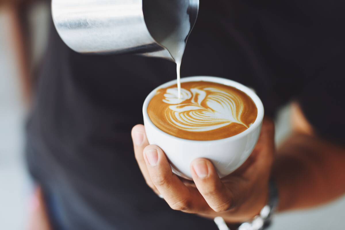 person pouring latte art
